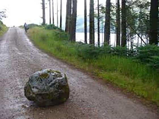 A rock in the middle of a dirt road is the metaphor for blocks to emotional success