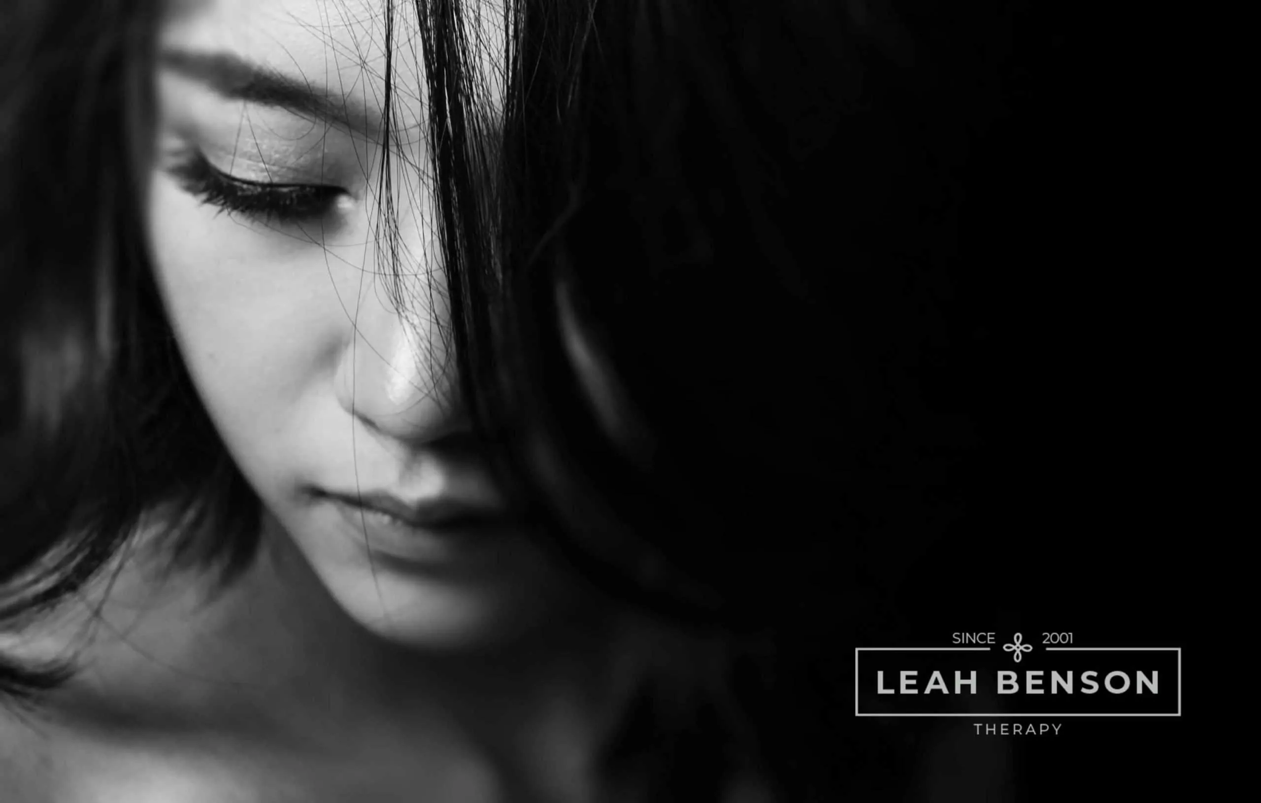 pensive attractive young women dealing with a breakup. LEAH BENSON THERAPY logo shown