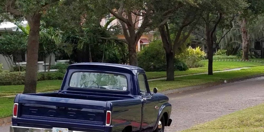 1960's blue Ford pickup truck parked in the Old Northeast of St Petersburg with the logo of Leah Benson Therapy